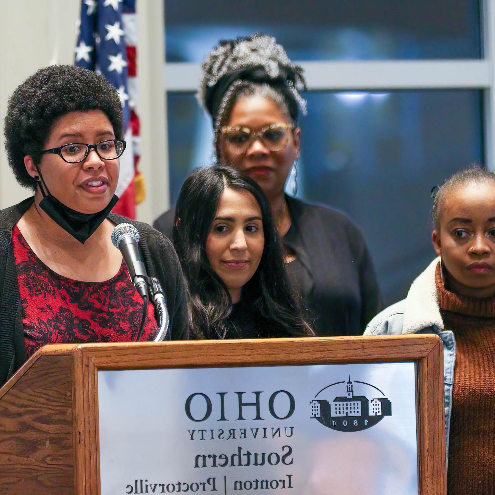 woman speaking at podium