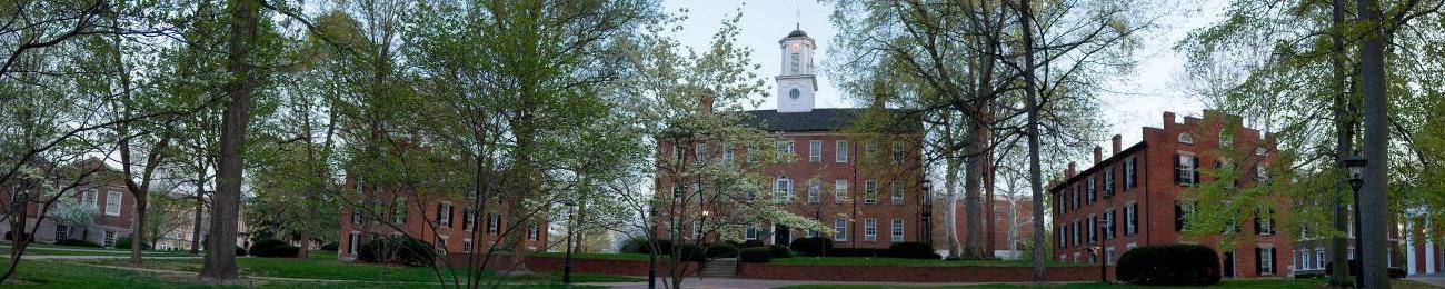 Cutler Hall surrounded by trees and nearby buildings on College Green