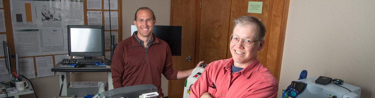 Professors pose in a lab